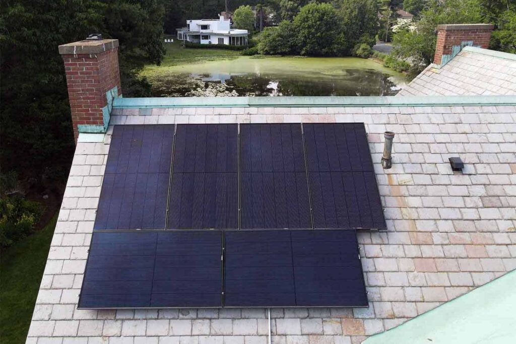 Solar panels mounted on a slate roof with the SlatePlate system, showing the finished installation