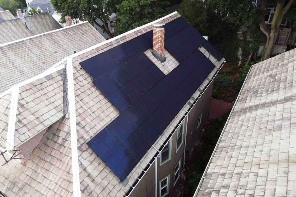 Solar panels mounted on a slate roof with the SlatePlate system, showing the finished installation
