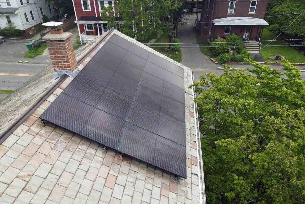 Solar panels mounted on a slate roof with the SlatePlate system, showing the finished installation