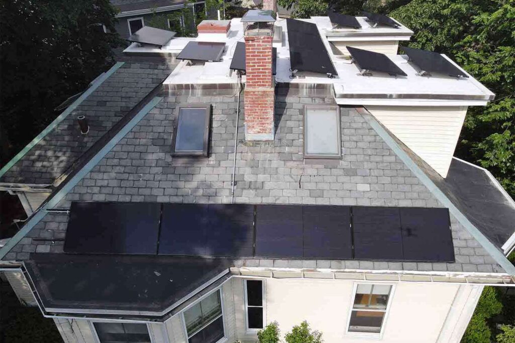 Solar panels mounted on a slate roof with the SlatePlate system, showing the finished installation