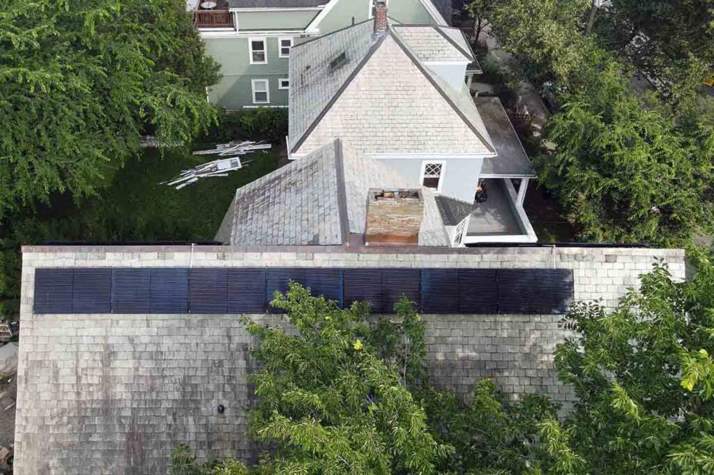 Solar panels mounted on a slate roof with the SlatePlate system, showing the finished installation
