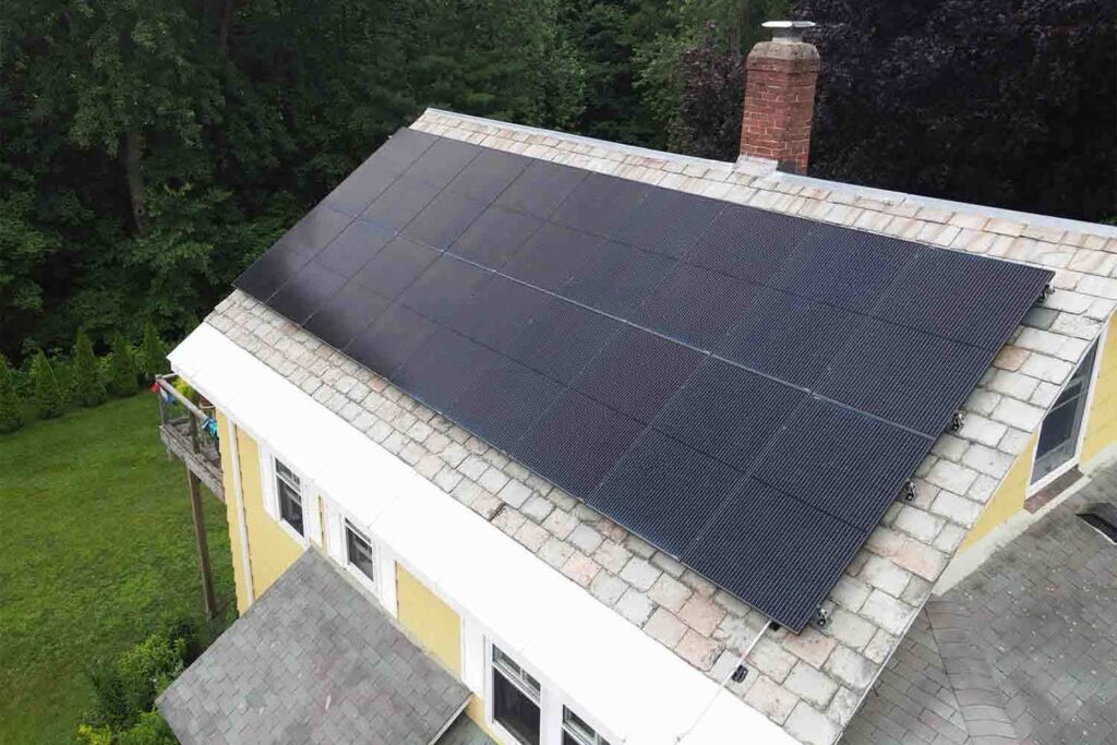 Solar panels mounted on a slate roof with the SlatePlate system, showing the finished installation