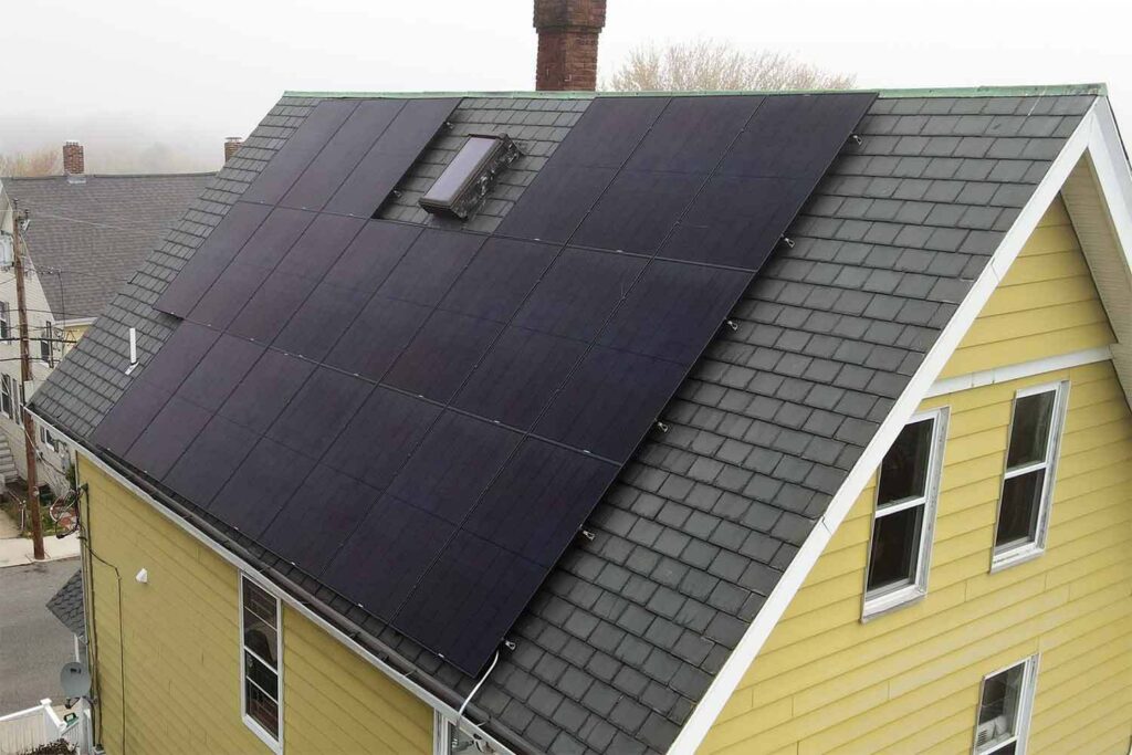 Solar panels mounted on a slate roof with the SlatePlate system, showing the finished installation