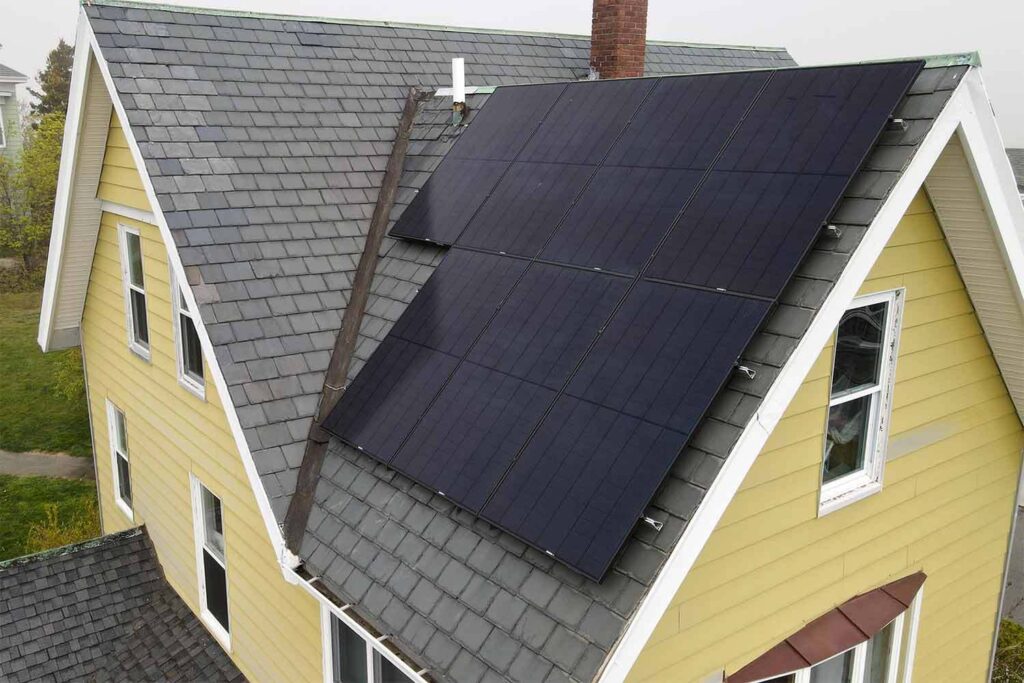 Solar panels mounted on a slate roof with the SlatePlate system, showing the finished installation