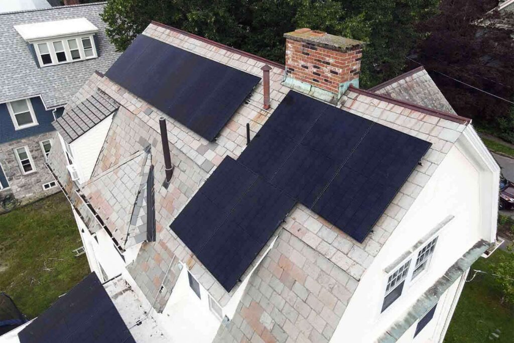 Solar panels mounted on a slate roof with the SlatePlate system, showing the finished installation