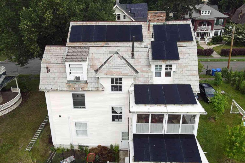 Solar panels mounted on a slate roof with the SlatePlate system, showing the finished installation